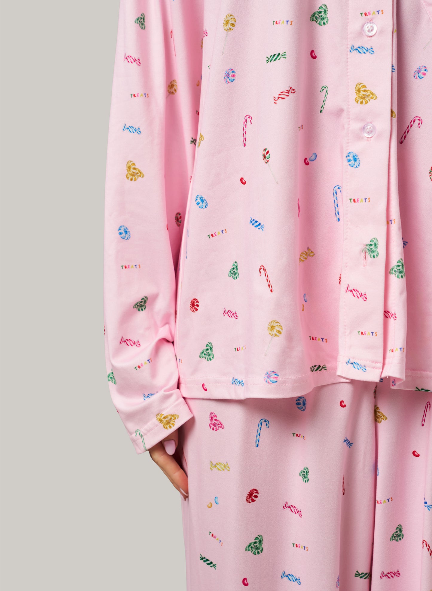 Pink pajama set with colorful patterns on a light gray background