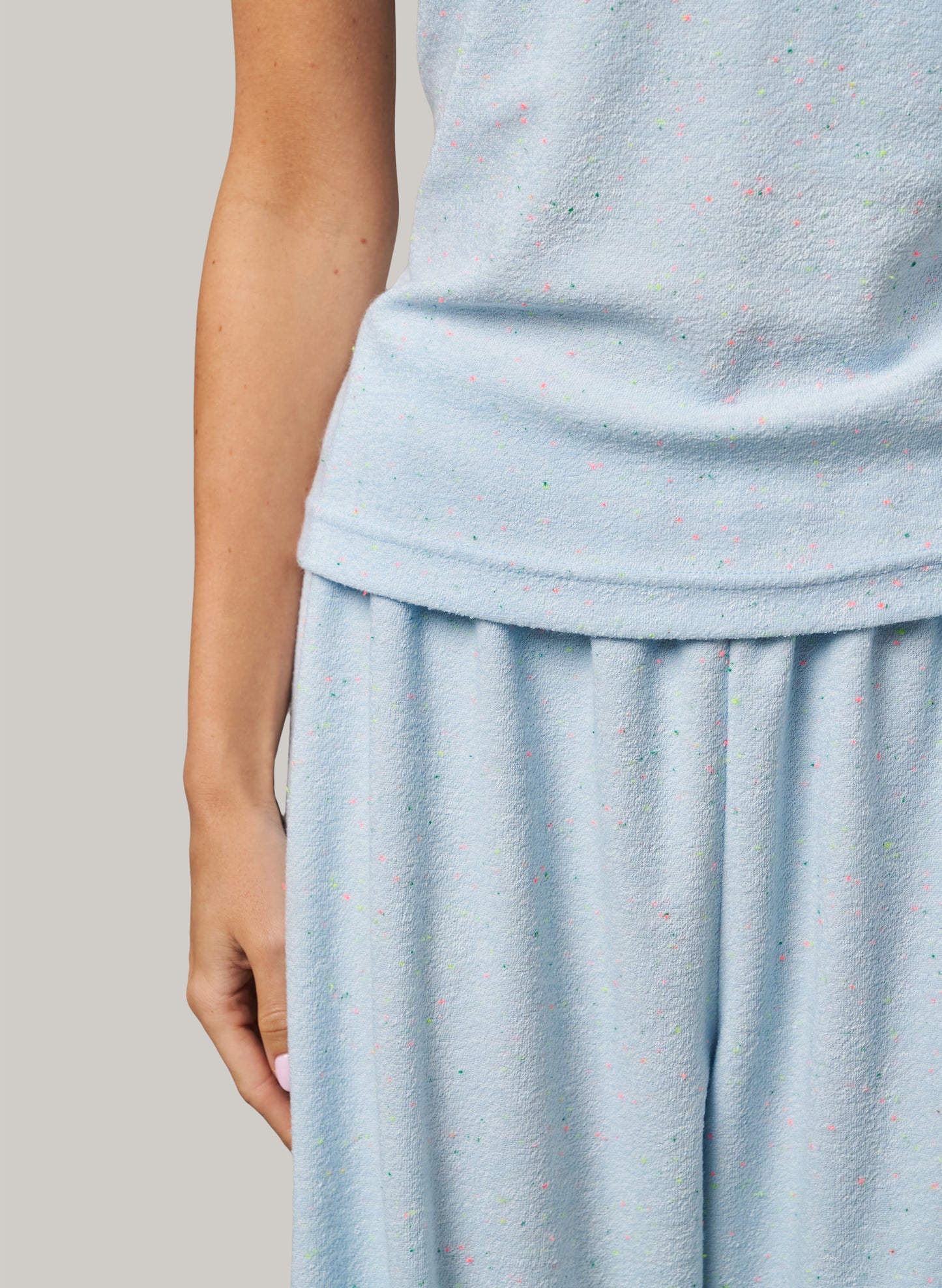 Light blue textured dress on a plain background