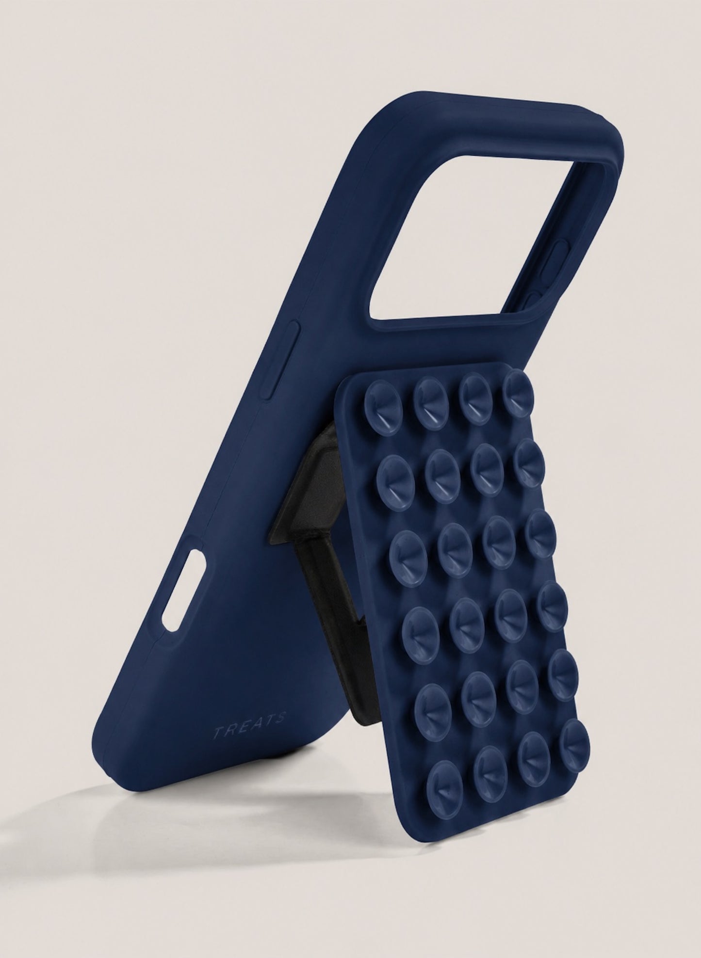 Navy blue phone case with suction cups on a light grey background