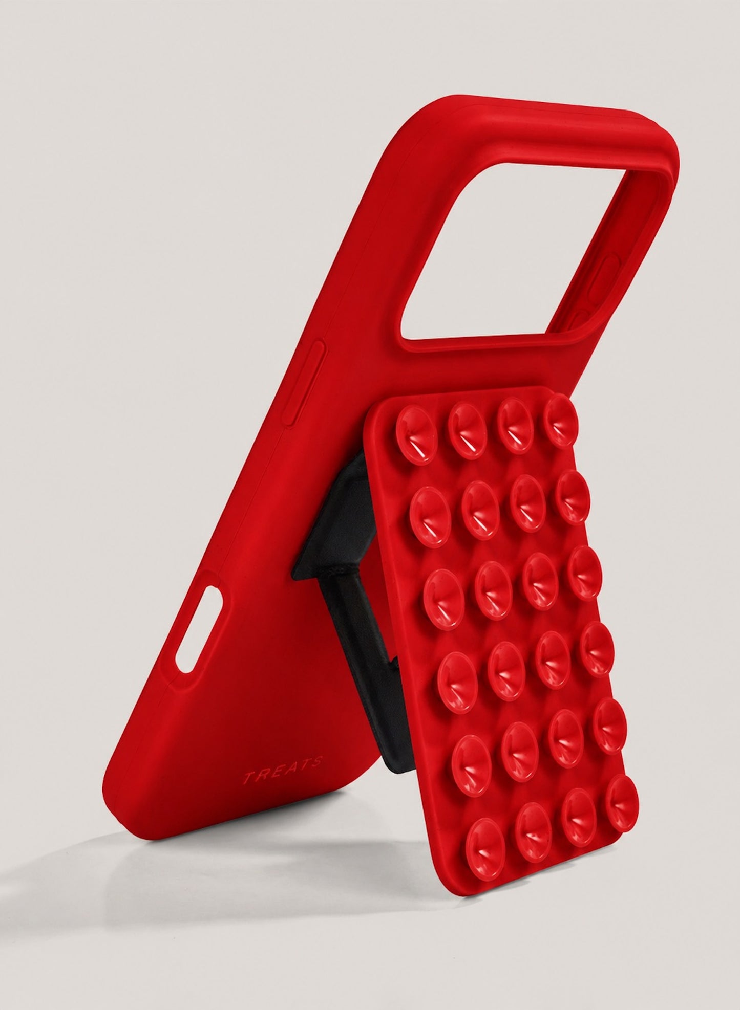 Red phone case with suction cup design on a light grey background