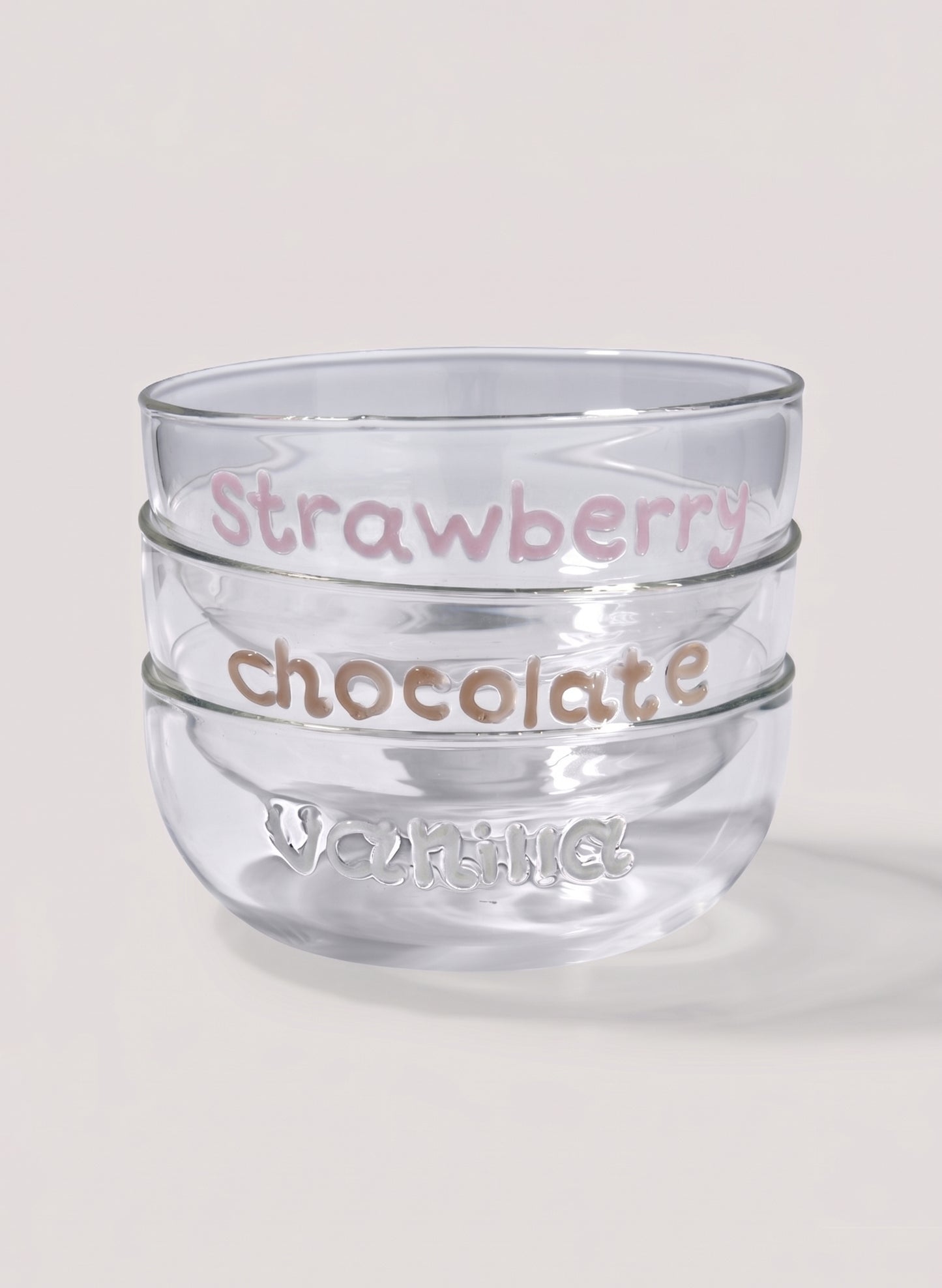 Clear glass dessert bowl with 'Strawberry chocolate' text and 'vanilla' writting on a light background