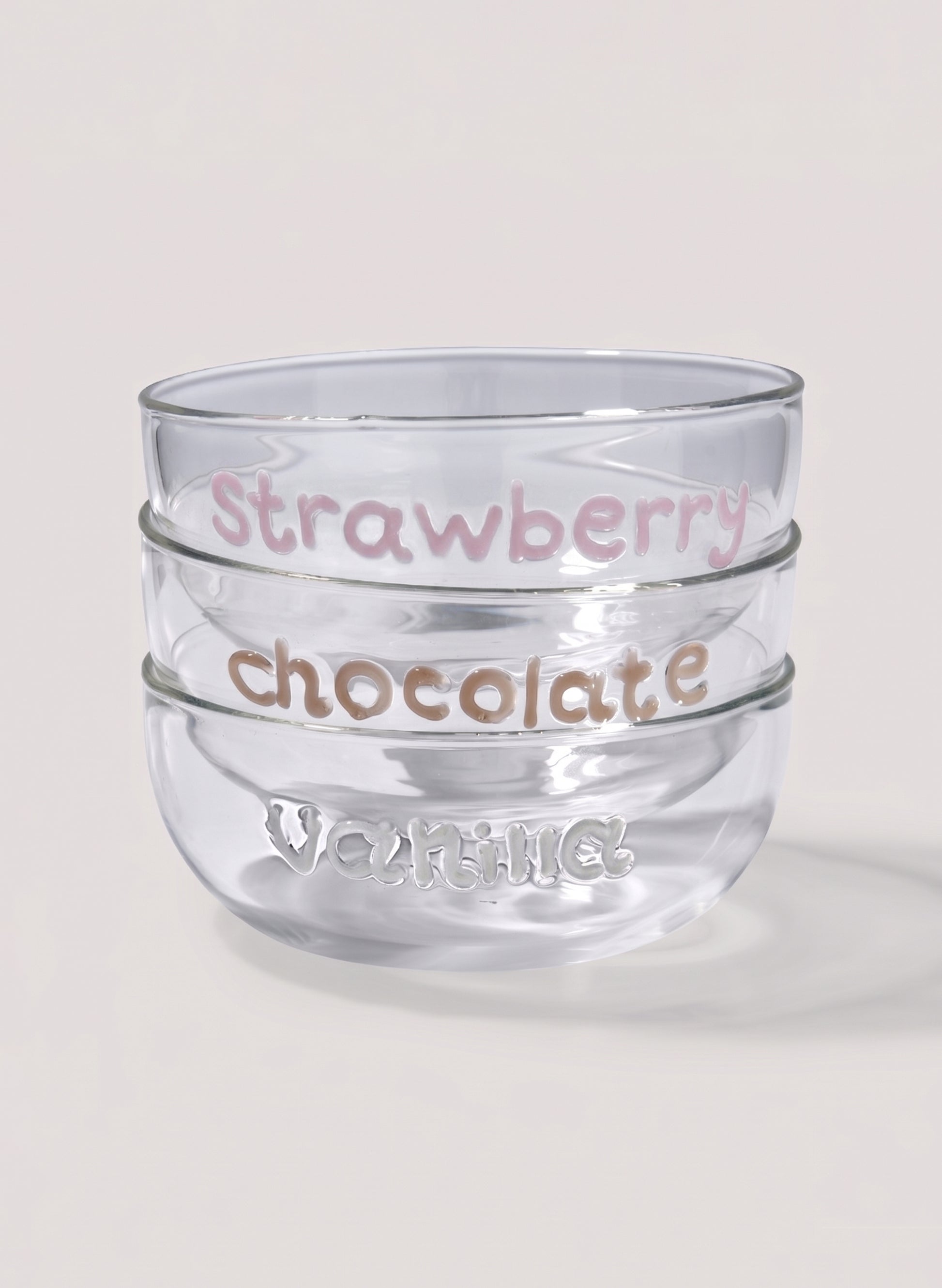 Clear glass dessert bowl with 'Strawberry chocolate' text and 'vanilla' writting on a light background