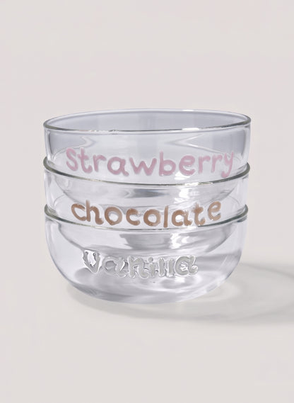 Clear glass dessert bowl with 'Strawberry chocolate' text and 'vanilla' writting on a light background