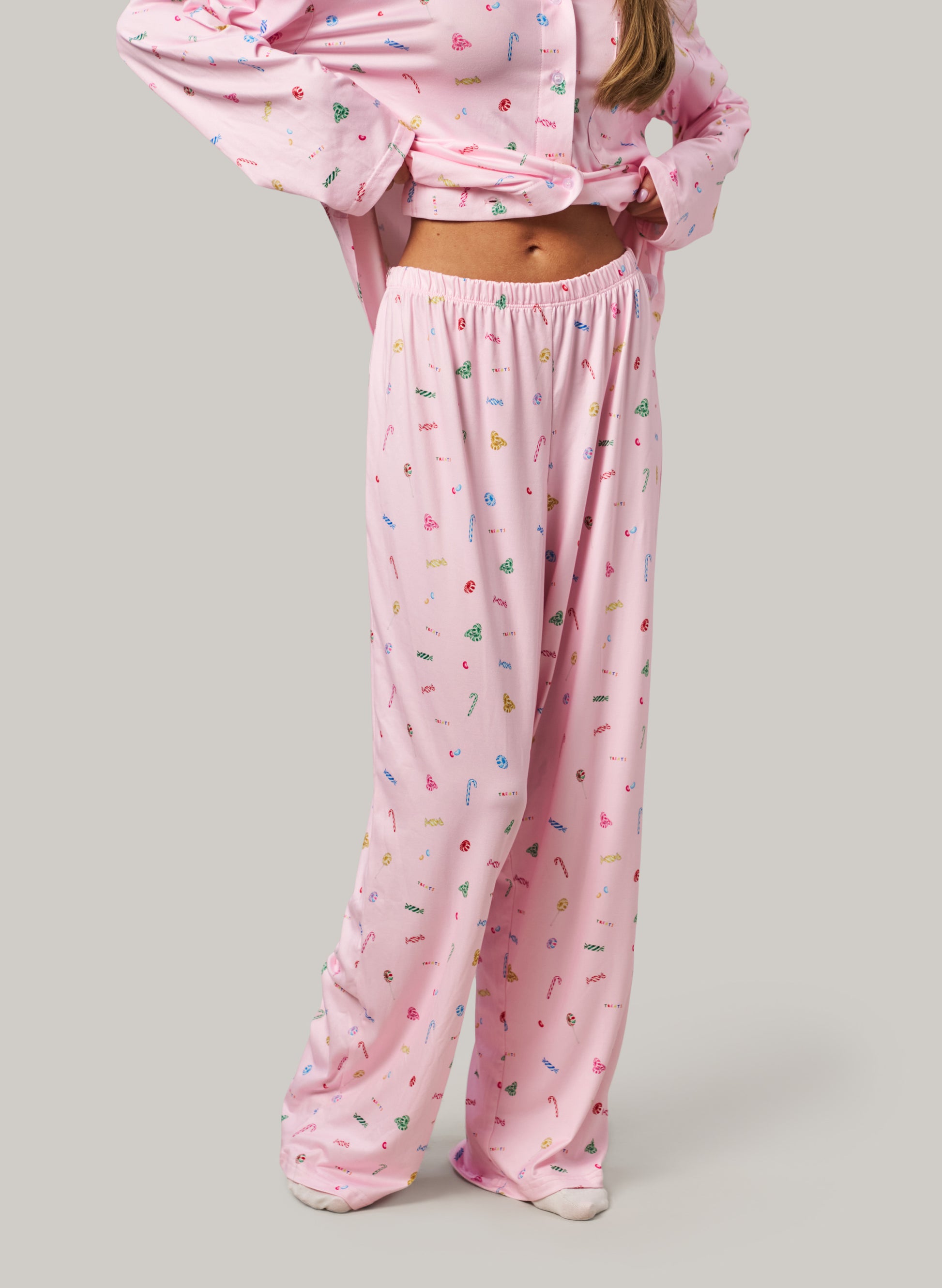 Pink pajama set with colorful sprinkles on a plain background