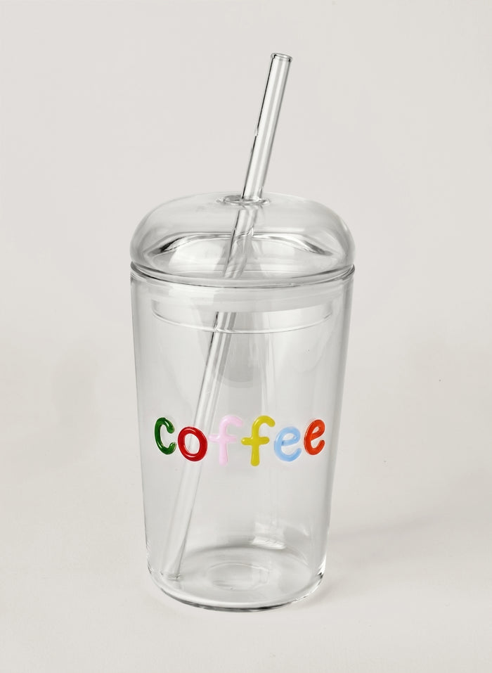 Clear tumbler with colorful 'coffee' text and a straw on a light gray background