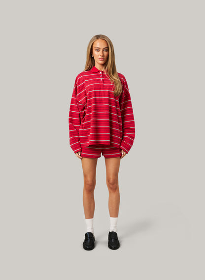 Person wearing a red and white striped outfit on a gray background