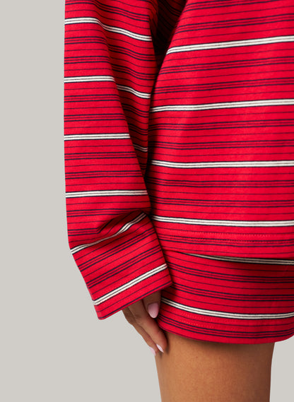 Red and white striped dress with long sleeves on a gray background