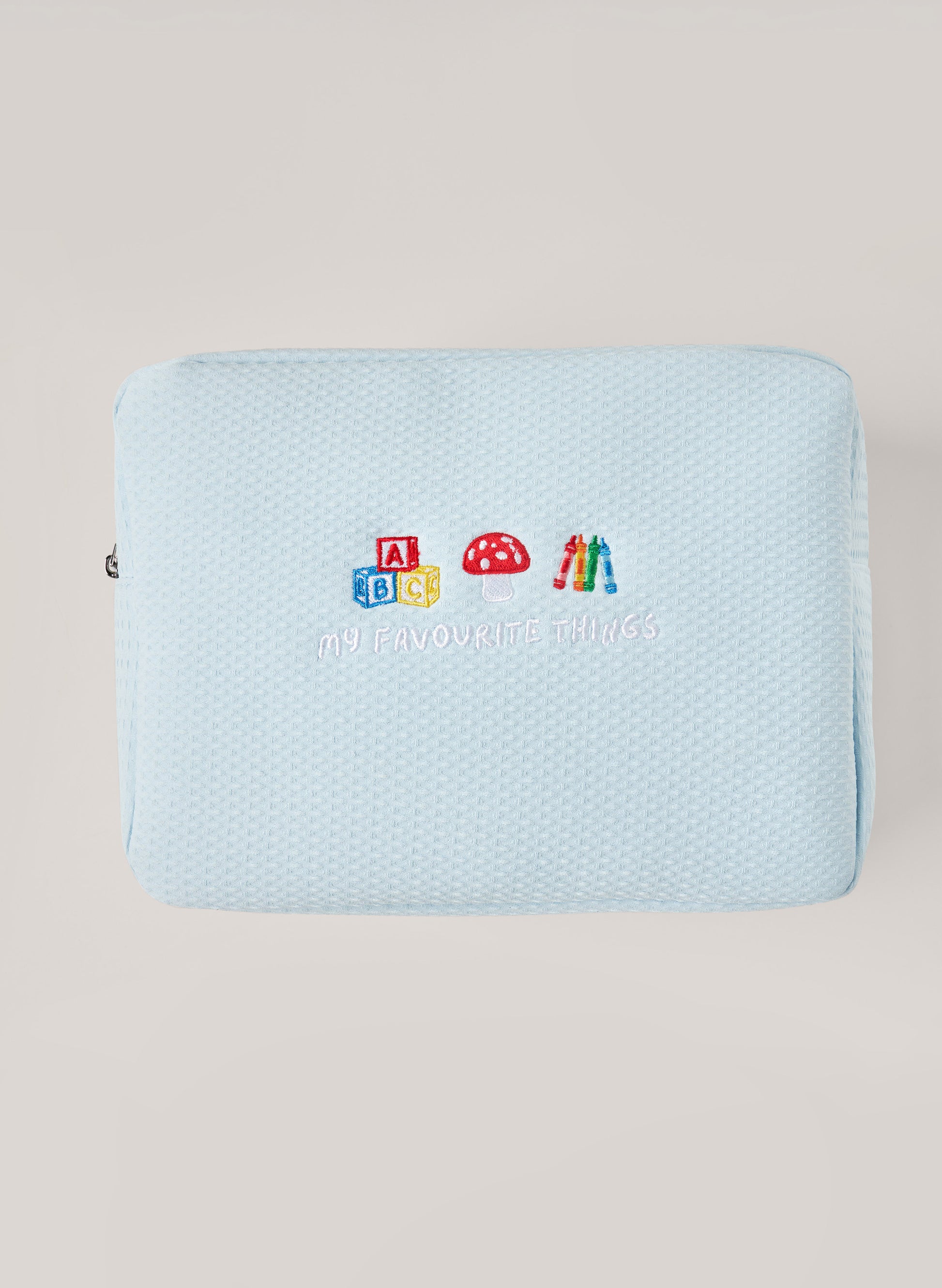 Light blue waffle-textured pouch with zipper closure, featuring a red embroidered heart and the words 'personalise me’ on the front