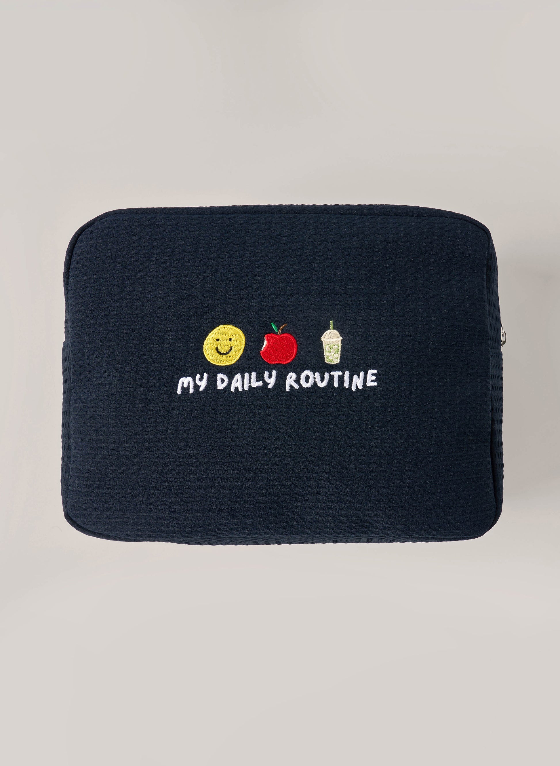 Navy waffle-textured pouch with zipper closure, featuring a red embroidered heart and the words 'personalise me’ on the front