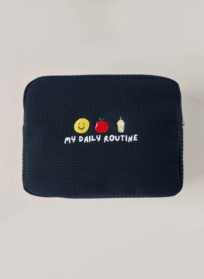Navy waffle-textured pouch with zipper closure, featuring a red embroidered heart and the words 'personalise me’ on the front