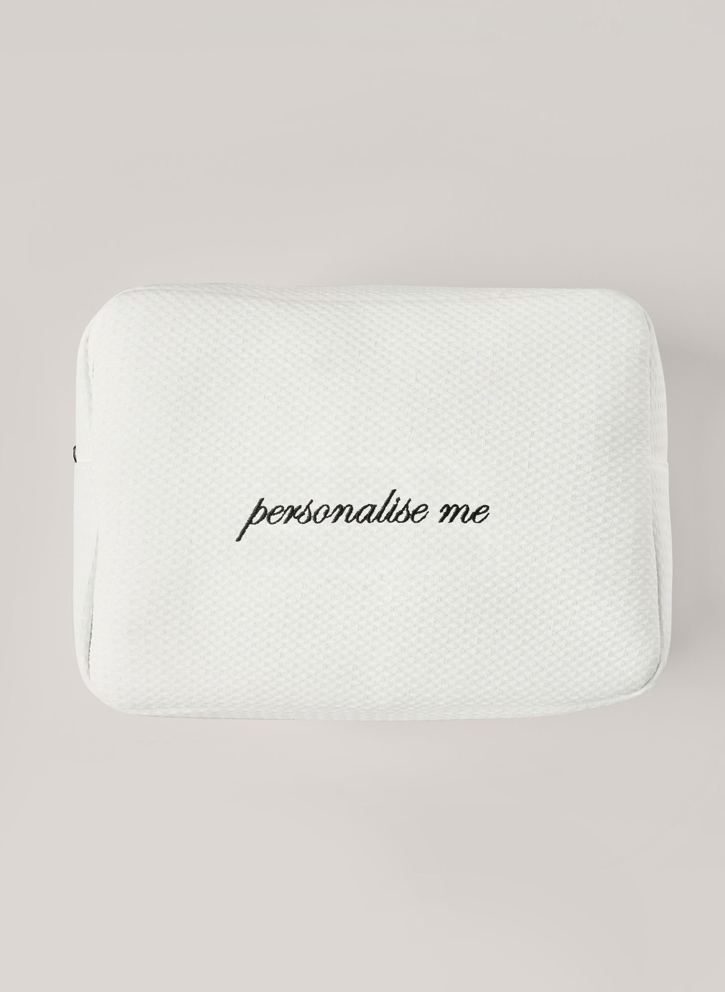 White waffle-textured pouch with zipper closure, featuring a red embroidered heart and the words 'personalise me’ on the front