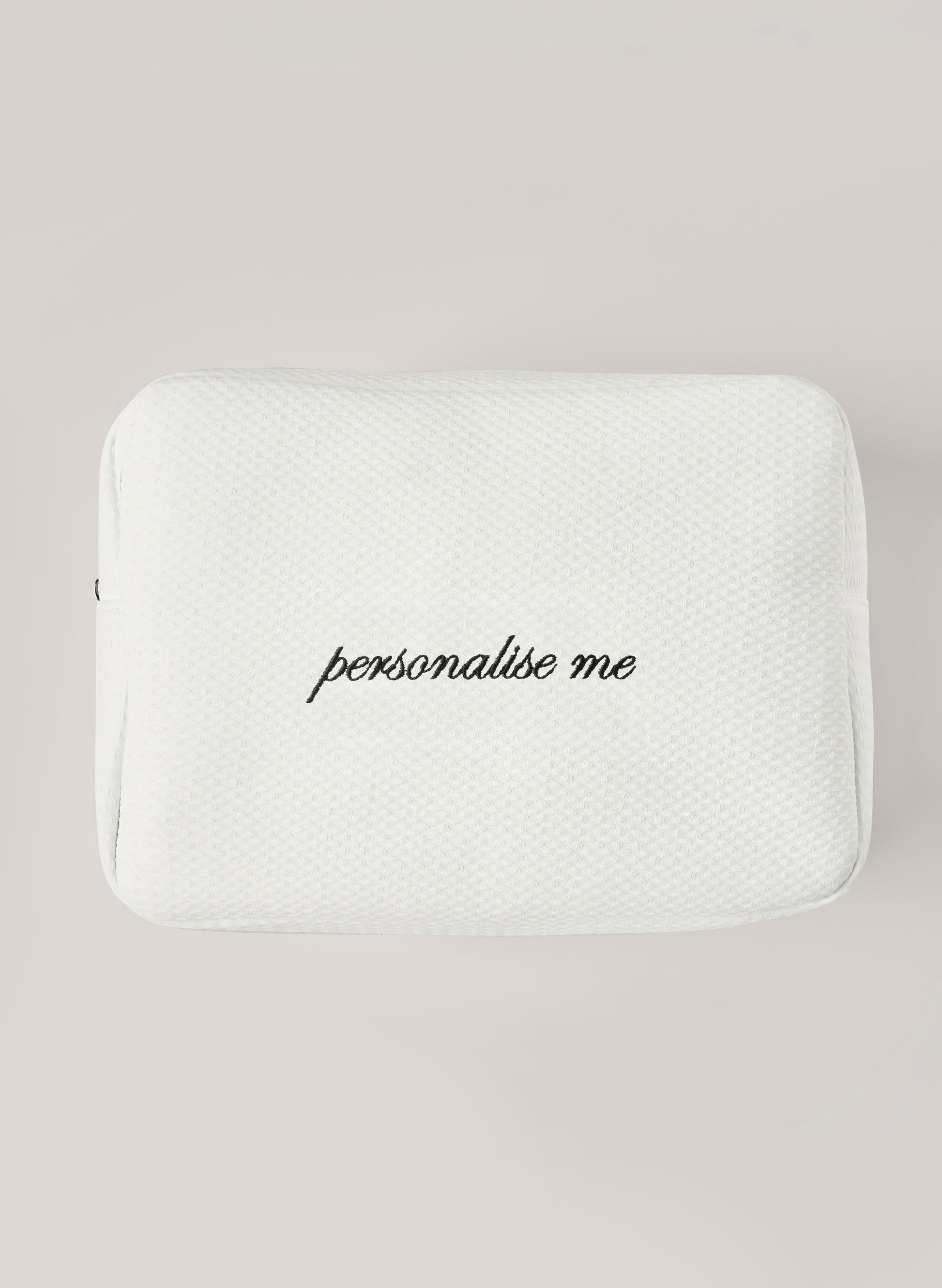 White waffle-textured pouch with zipper closure, featuring a red embroidered heart and the words 'personalise me’ on the front