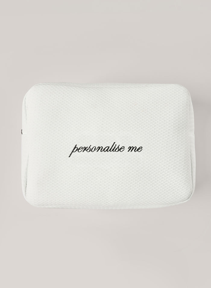 White waffle-textured pouch with zipper closure, featuring a red embroidered heart and the words 'personalise me’ on the front