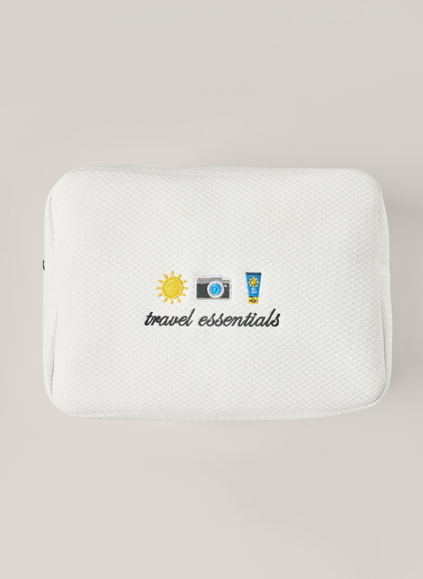 White waffle-textured pouch with zipper closure, featuring a red embroidered heart and the words 'personalise me’ on the front