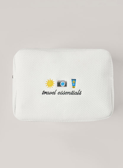 White waffle-textured pouch with zipper closure, featuring a red embroidered heart and the words 'personalise me’ on the front
