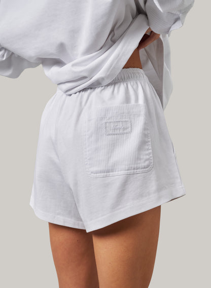 Light gray shorts worn by a person on a neutral background