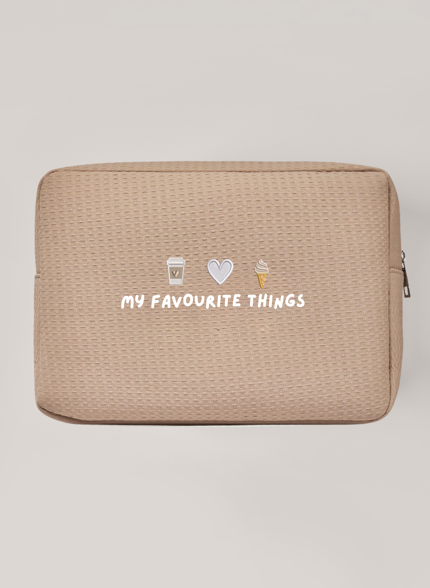 Beige Waffle Bag with silver zipper saying 'my favourite things' with embroidery icons above of a coffee cup, a heart and ice cream