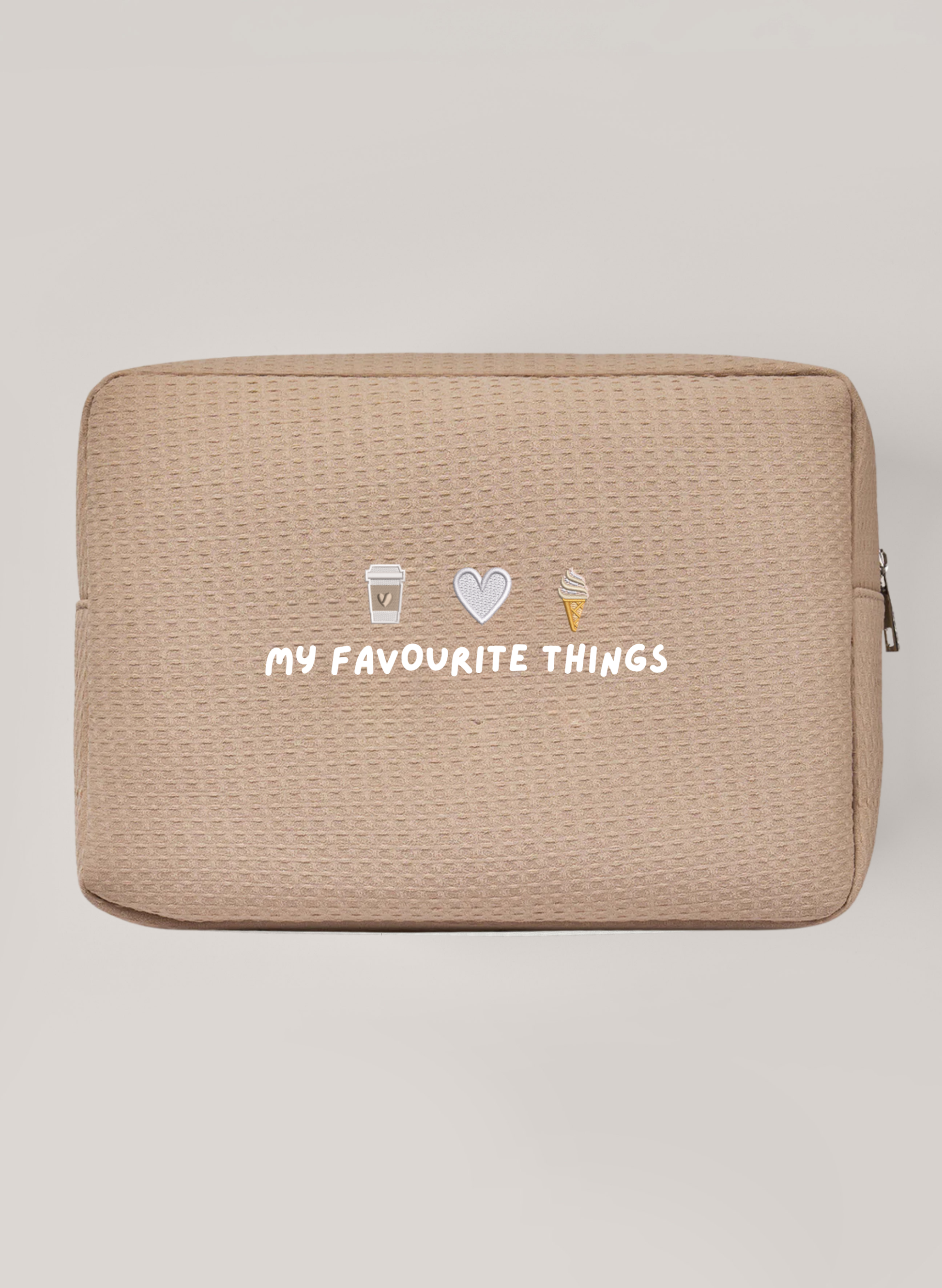 Beige Waffle Bag with silver zipper saying 'my favourite things' with embroidery icons above of a coffee cup, a heart and ice cream