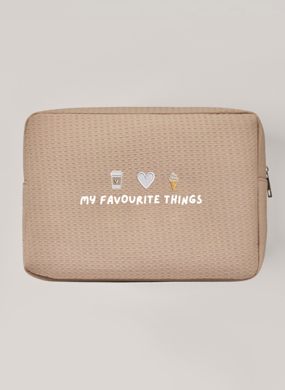 Beige Waffle Bag with silver zipper saying 'my favourite things' with embroidery icons above of a coffee cup, a heart and ice cream