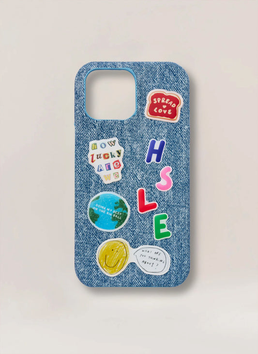 Denim phone case with colorful stickers on a light gray background