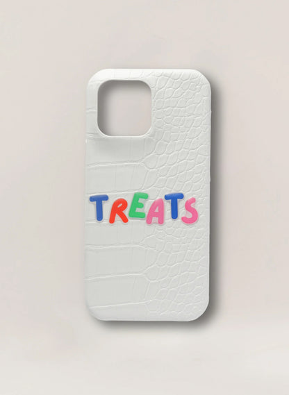 Phone case with 'TREATS' text in colorful letters on a light background