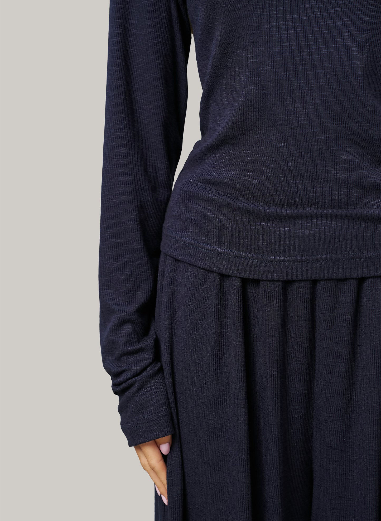 Navy long-sleeve top and skirt set on a plain background