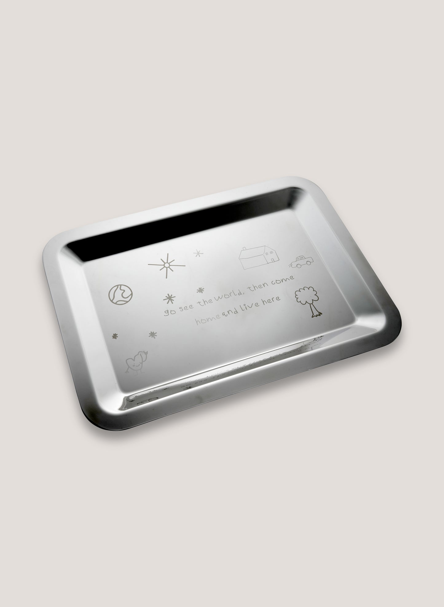Silver tray with engraved symbols and text on a light gray background