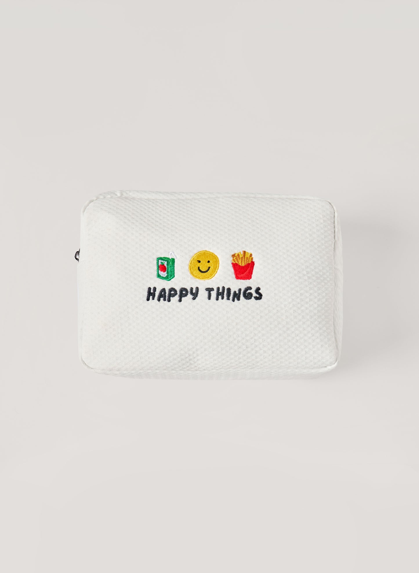 White waffle-textured pouch with zipper closure, featuring embroidered drink, smiley face, and fries icons with ‘happy things’ text on the front