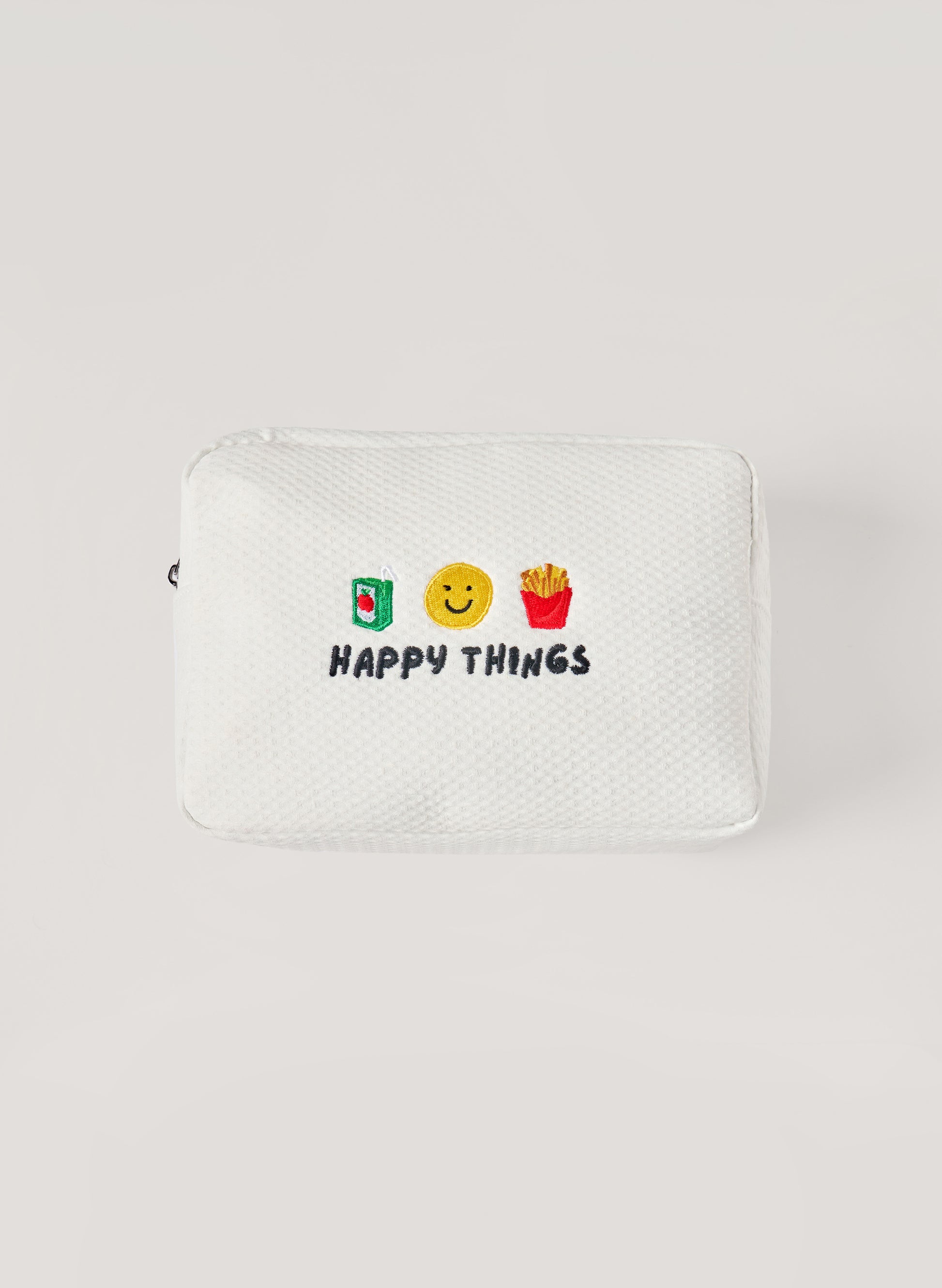 White waffle-textured pouch with zipper closure, featuring embroidered drink, smiley face, and fries icons with ‘happy things’ text on the front