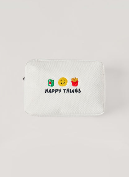 White waffle-textured pouch with zipper closure, featuring embroidered drink, smiley face, and fries icons with ‘happy things’ text on the front