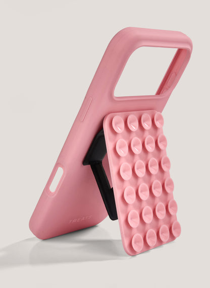 Pink phone case with bubble texture on a light gray background