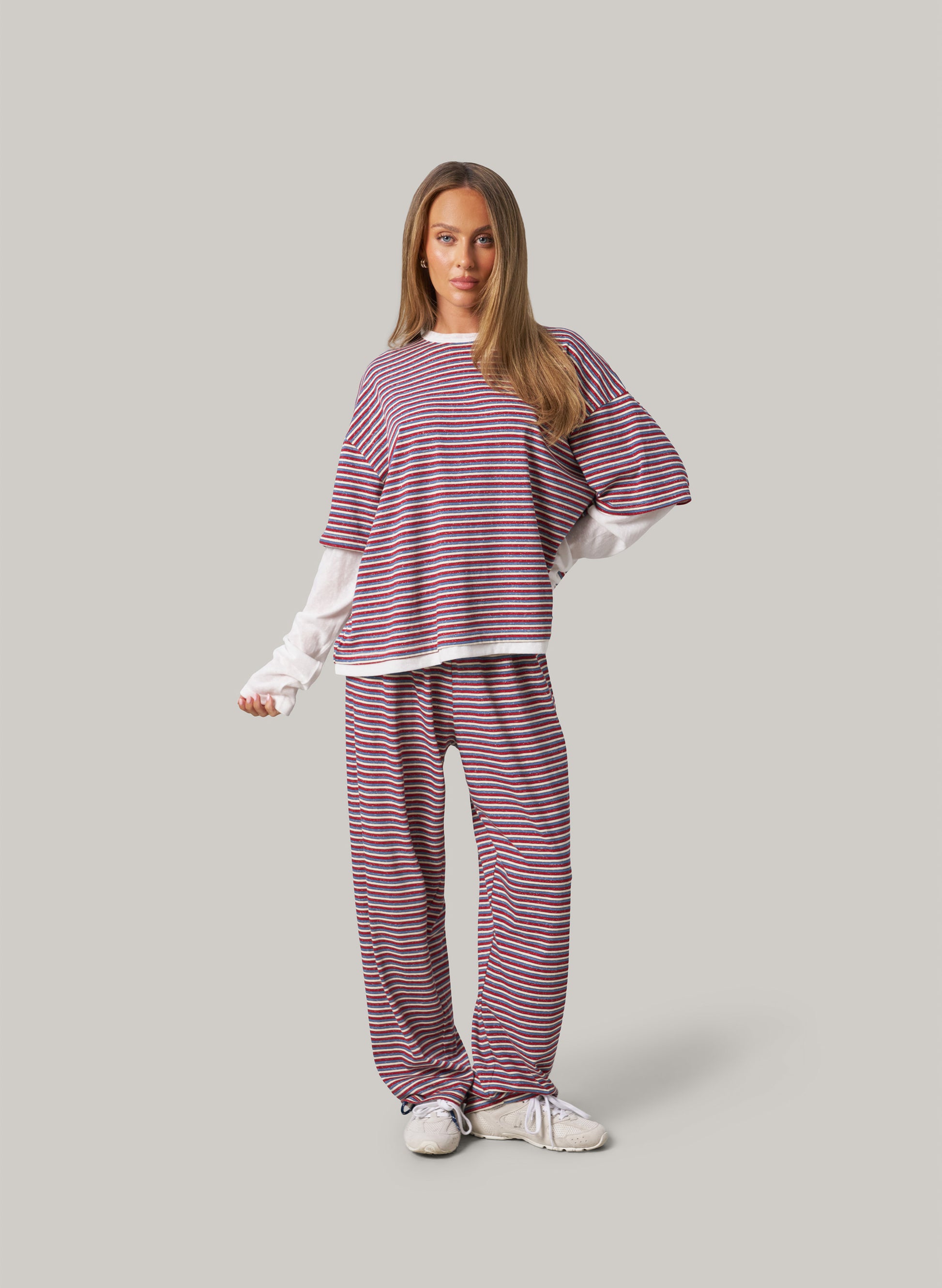 Person wearing a striped outfit on a plain background