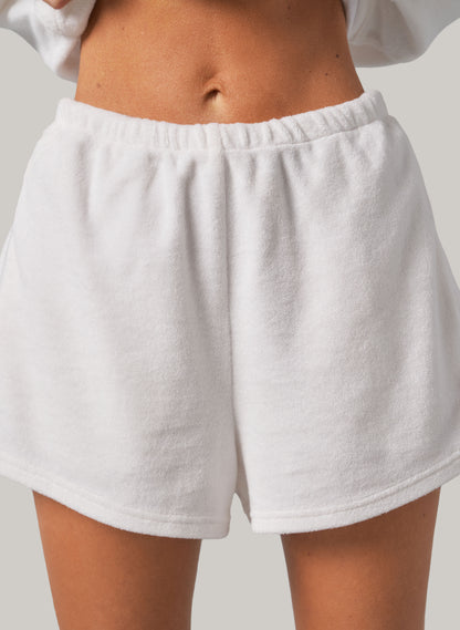 White shorts worn by a person on a neutral background