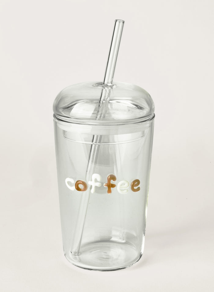 Clear glass tumbler with a straw and 'coffee' text on a light grey background