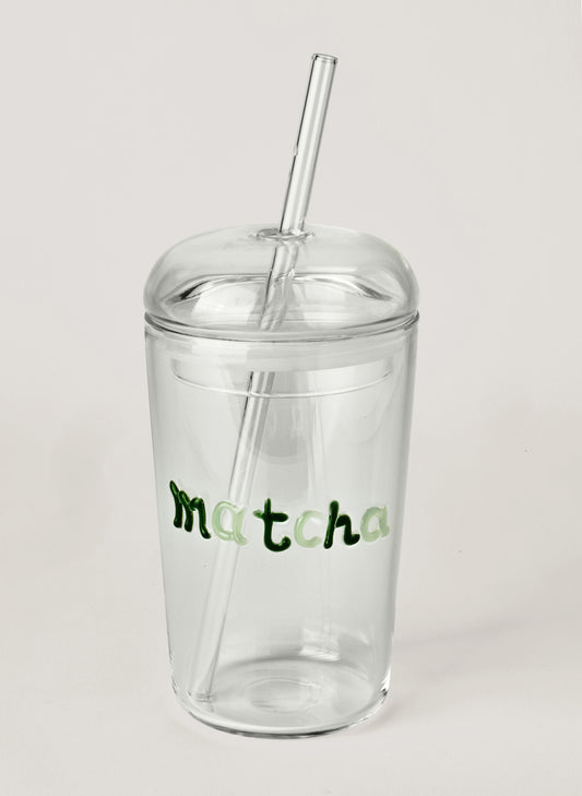 Clear tumbler with straw and 'matcha' text on a light gray background
