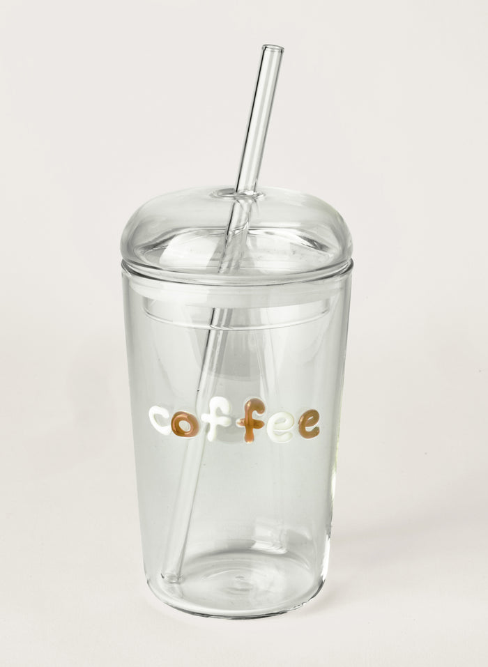 Clear tumbler with 'coffee' text and straw on a white background