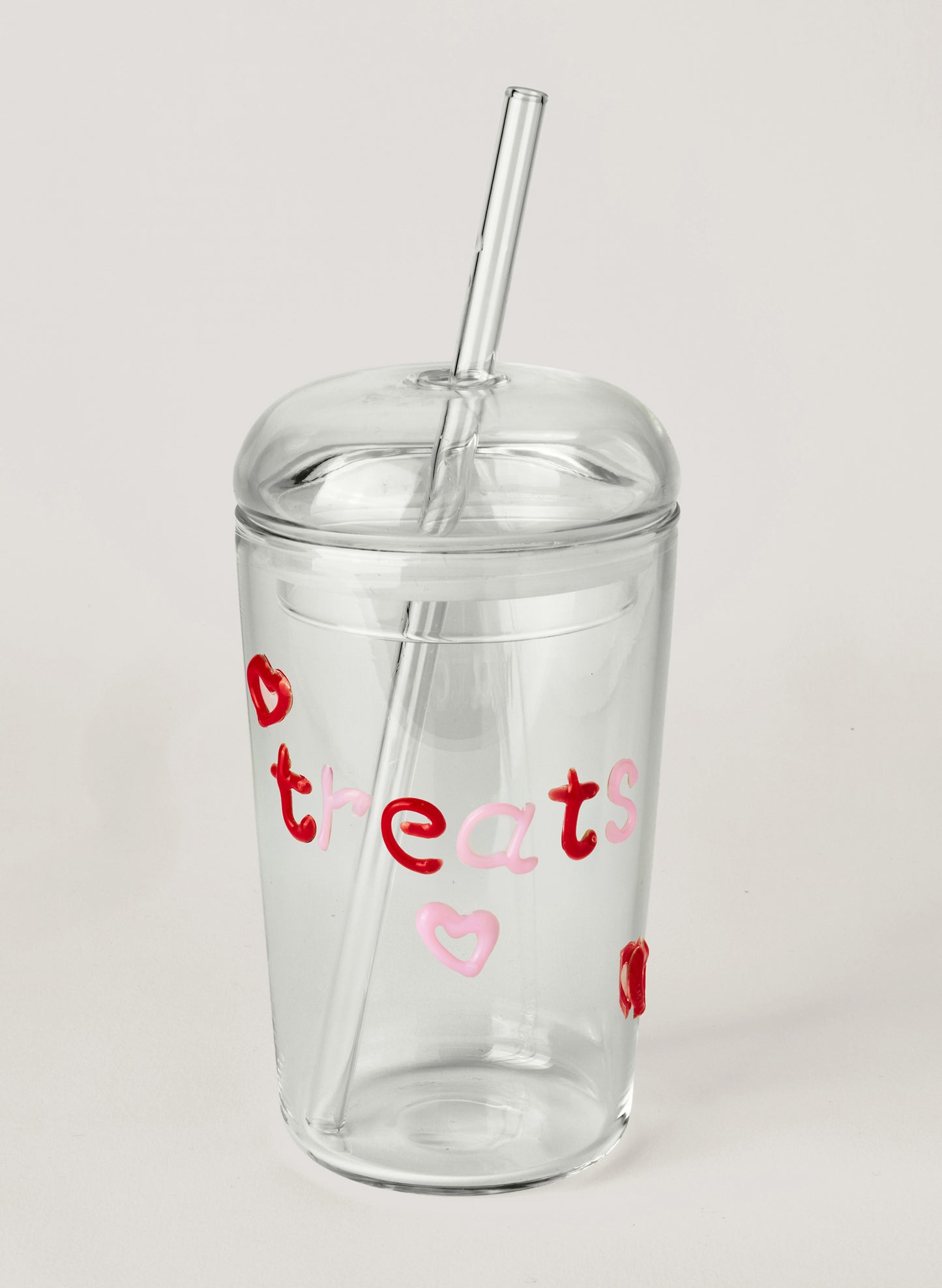 Clear tumbler with red and pink text on a white background