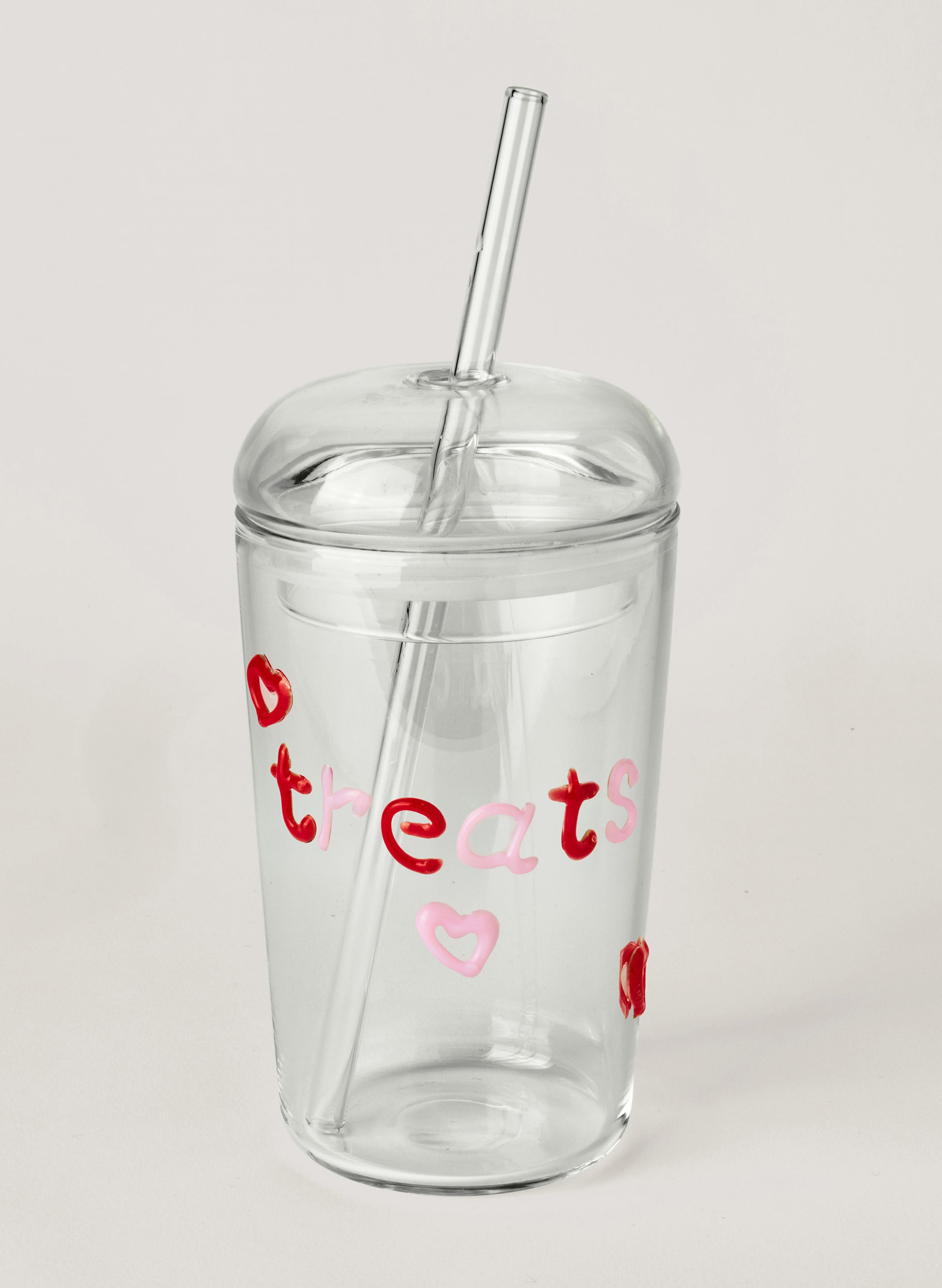 Clear tumbler with red and pink text on a white background