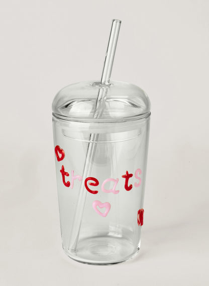Clear tumbler with red and pink text on a white background