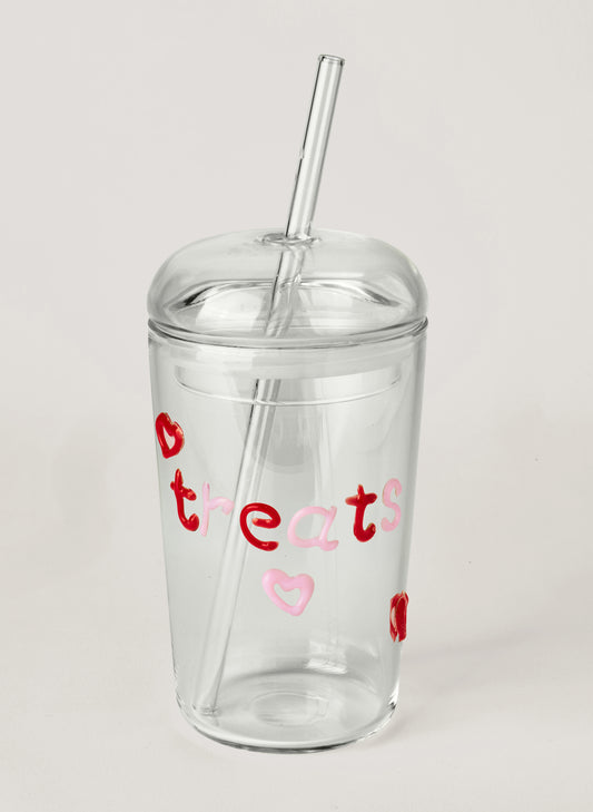 Clear tumbler with red and pink text on a white background