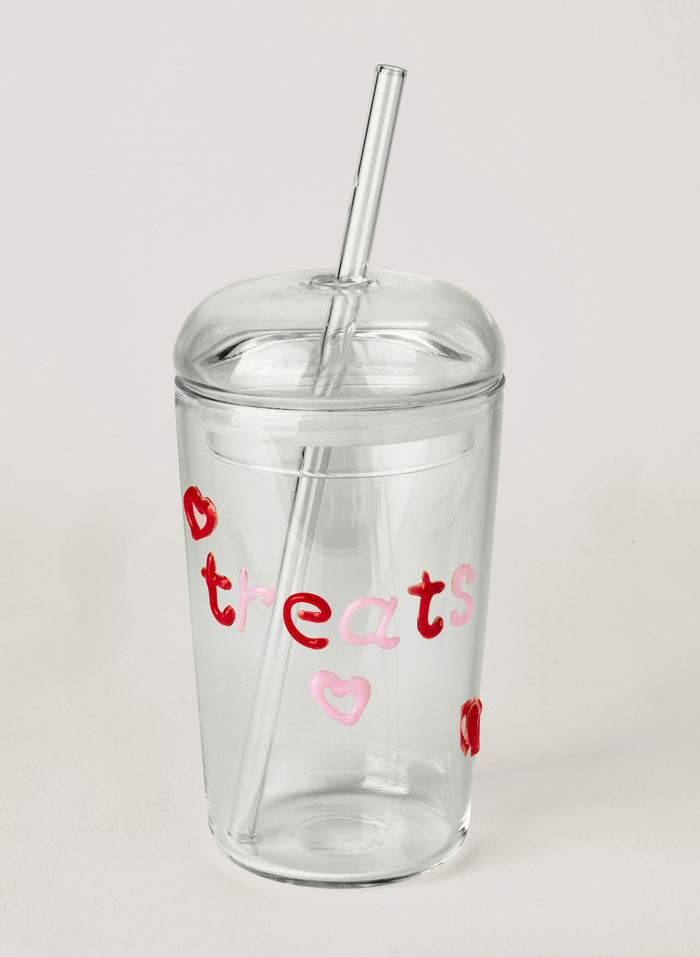 Clear tumbler with red and pink text on a white background