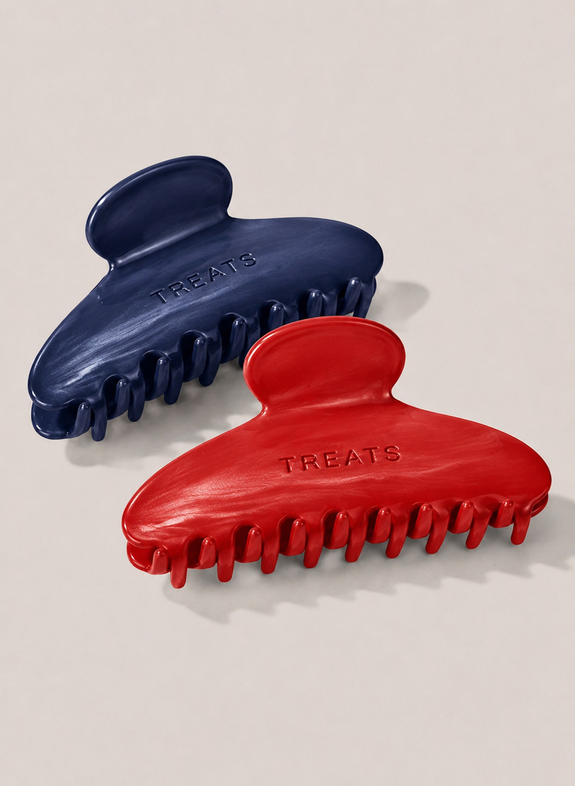 Two Claw lips, one red, one navy with 'treats' written on both