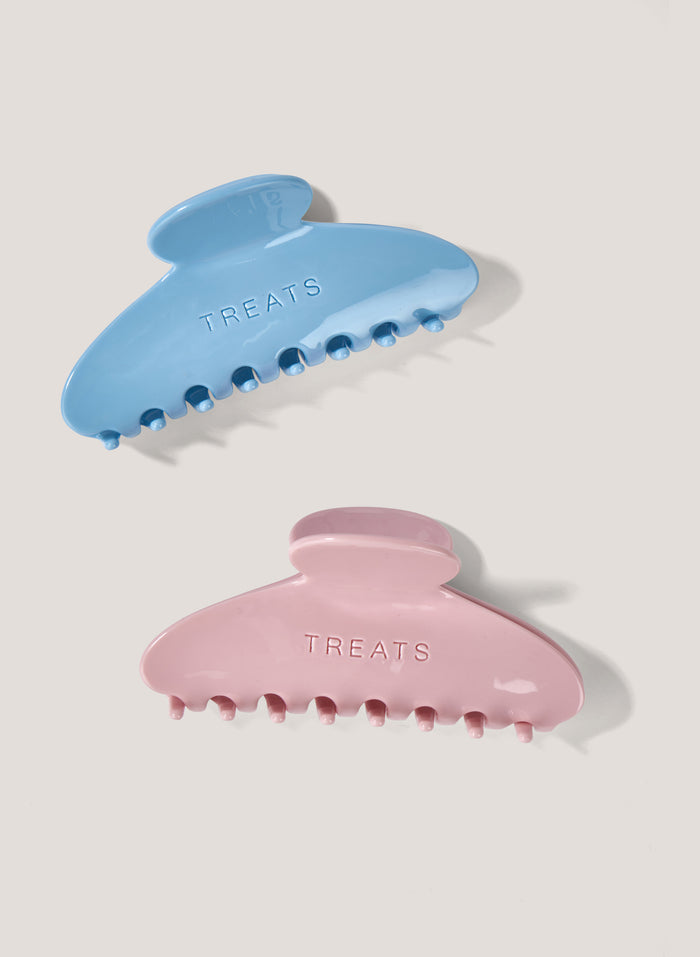 Two claw clips, one blue and one pink, on a white background.