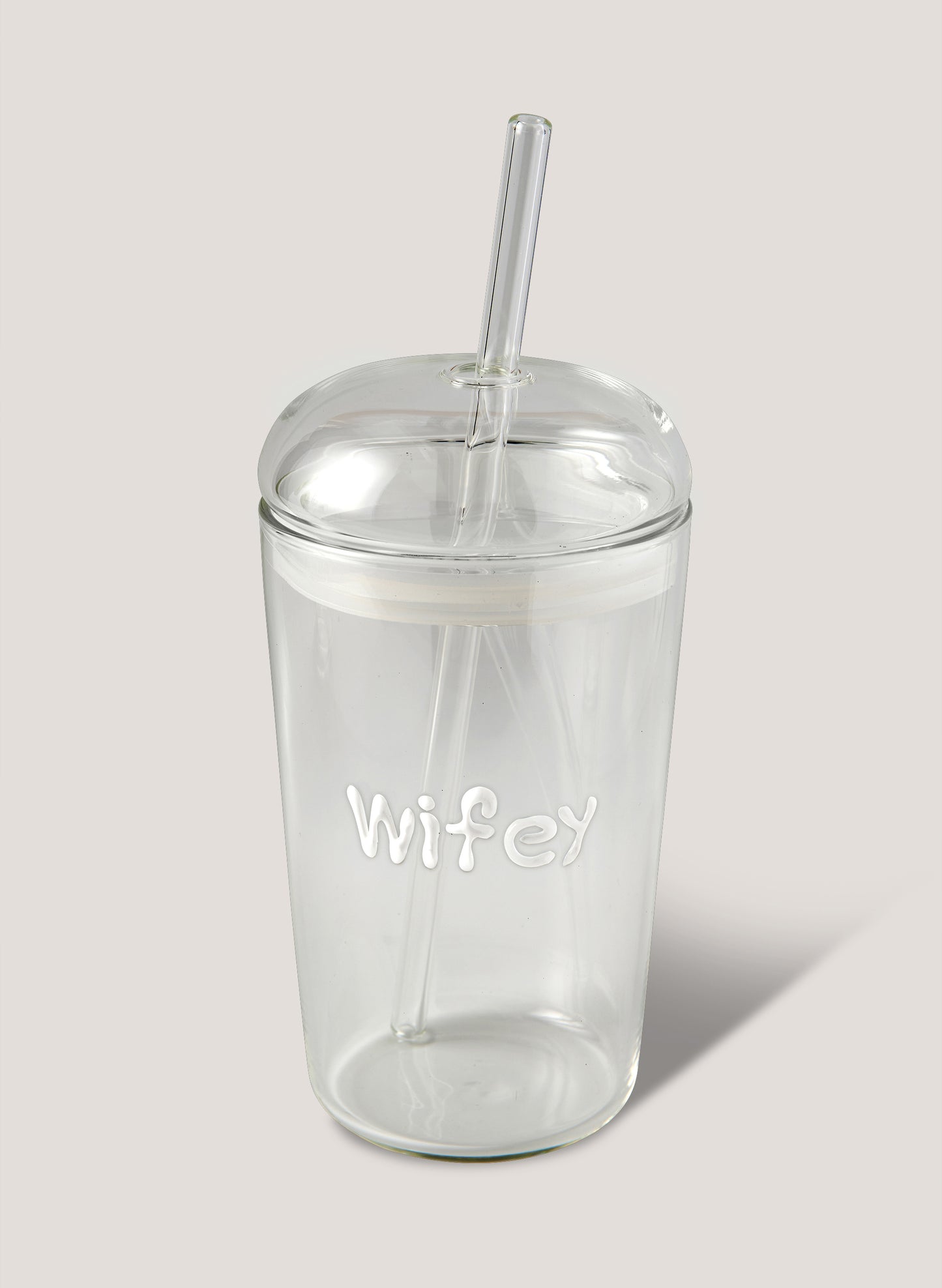 Clear tumbler with 'Wifey' text and straw on a light grey background