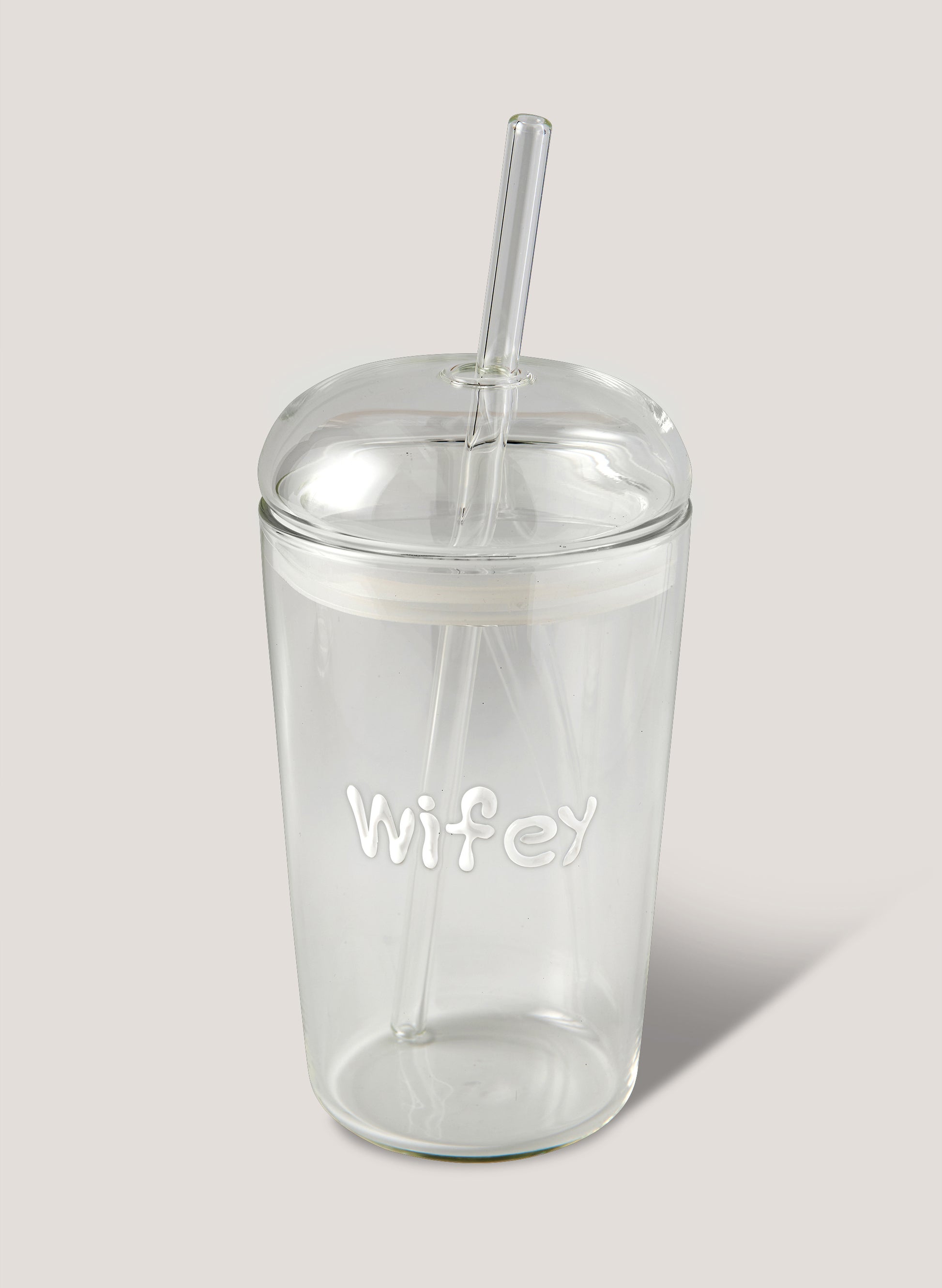 Clear tumbler with 'Wifey' text and straw on a light grey background