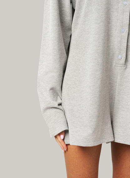 Grey oversized romper worn by a person on a plain background